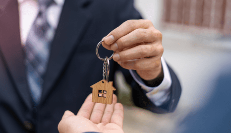 Businessman handing off house keys to homeowner